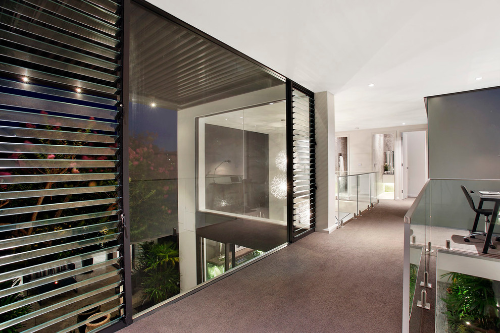 Inspiration for a large contemporary hallway in Sydney with white walls and carpet.