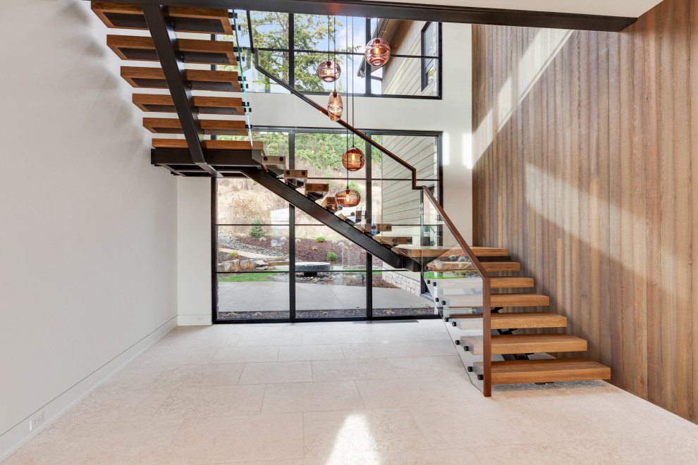 Idées déco pour un escalier contemporain avec des marches en bois et un garde-corps en matériaux mixtes.