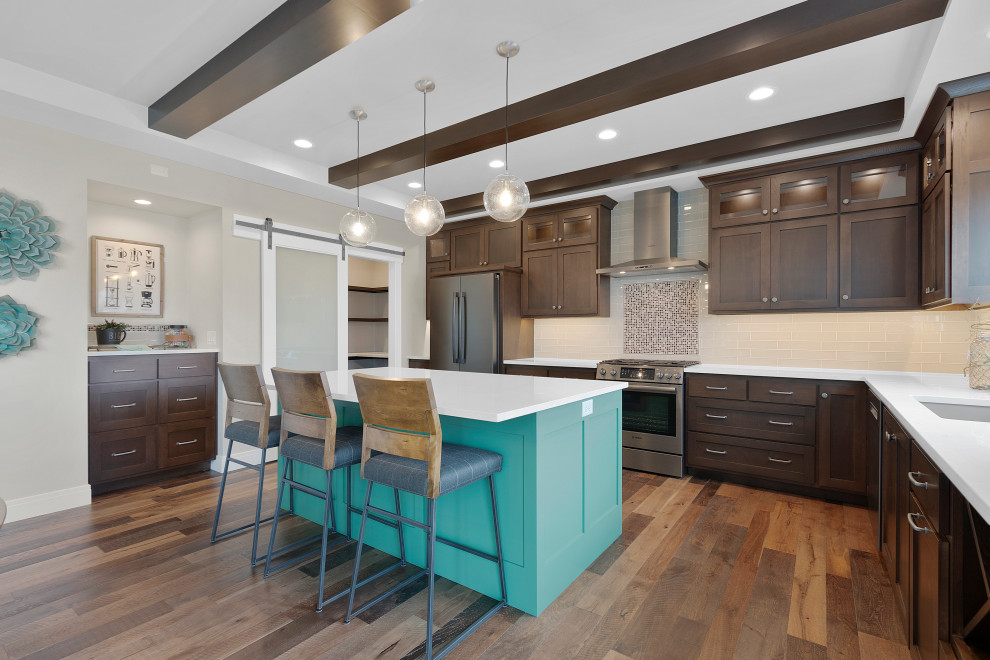 Mid-sized transitional l-shaped medium tone wood floor, brown floor and tray ceiling kitchen pantry photo with an undermount sink, shaker cabinets, medium tone wood cabinets, quartz countertops, gray backsplash, glass tile backsplash, black appliances, an island and white countertops