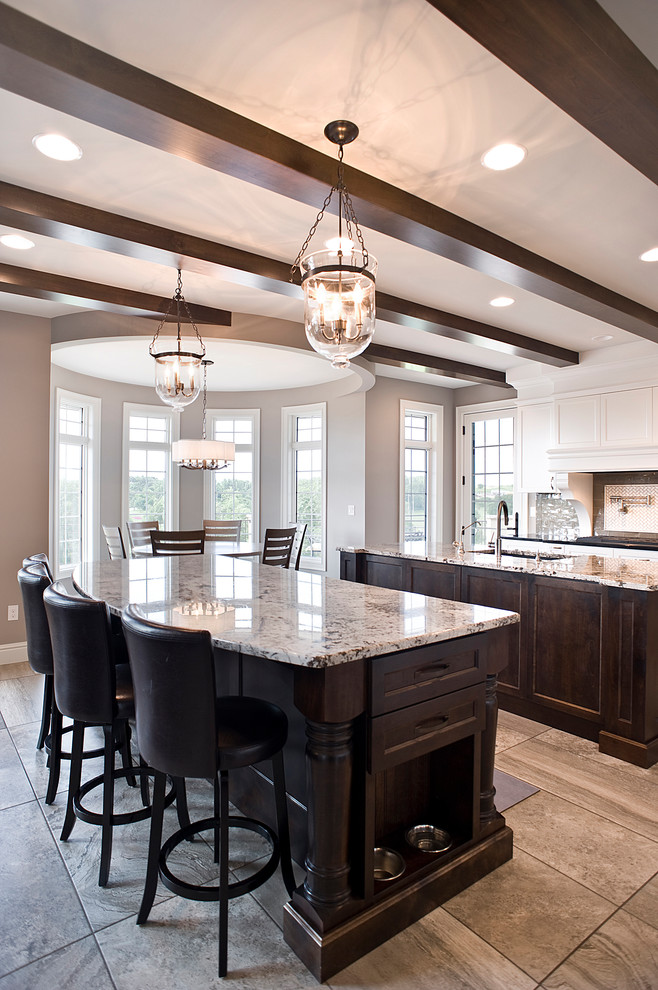 Eat-in kitchen - large transitional l-shaped porcelain tile and multicolored floor eat-in kitchen idea with an undermount sink, raised-panel cabinets, dark wood cabinets, granite countertops, paneled appliances and two islands