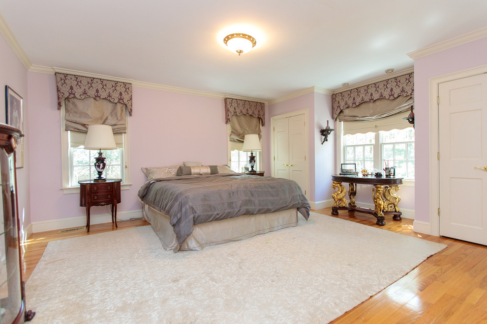 This is an example of an expansive traditional guest bedroom in Boston with purple walls, medium hardwood floors and multi-coloured floor.