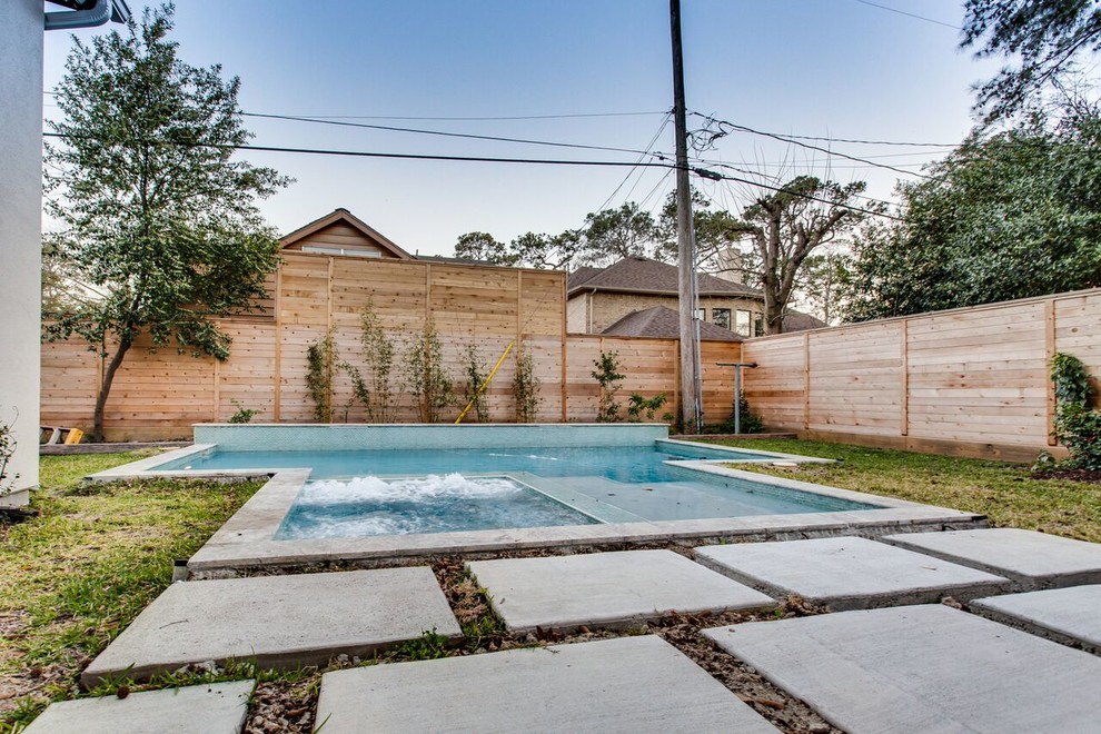 Mid-sized modern backyard rectangular lap pool in Houston with a hot tub and tile.