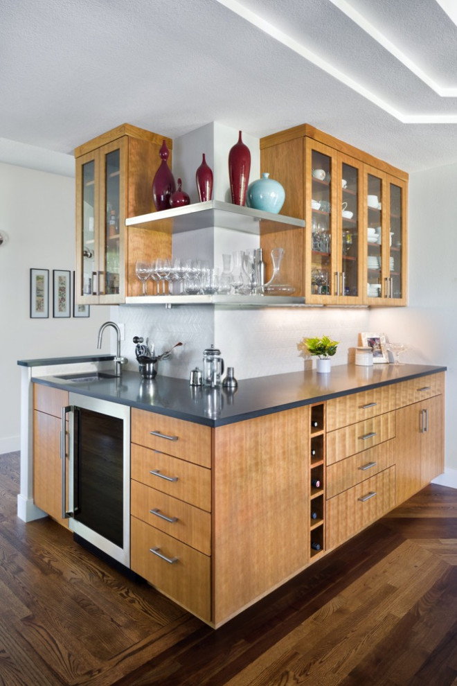Design ideas for a midcentury l-shaped wet bar in Denver with an undermount sink, glass-front cabinets, light wood cabinets, ceramic splashback and dark hardwood floors.
