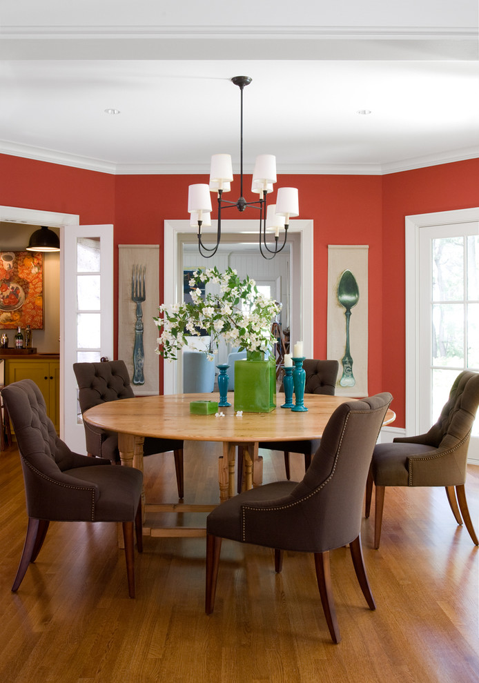 This is an example of a traditional dining room in Portland Maine with orange walls.