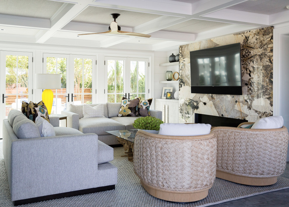 Inspiration for a beach style open concept living room in Other with white walls, a standard fireplace, a stone fireplace surround, a wall-mounted tv and coffered.