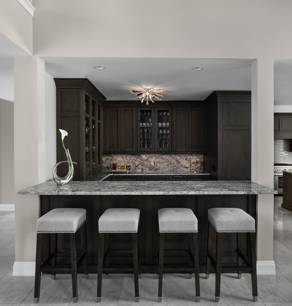 Design ideas for a transitional u-shaped wet bar in Detroit with an undermount sink, recessed-panel cabinets, dark wood cabinets, grey splashback, grey floor and grey benchtop.