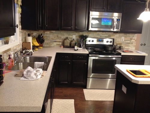 Kitchen backsplash and fireplace. Does it need to match? I have recently installed a stone backsplash in my kitchen. I want to add character to my fireplace by adding a veneer/trim of sorts. My question is