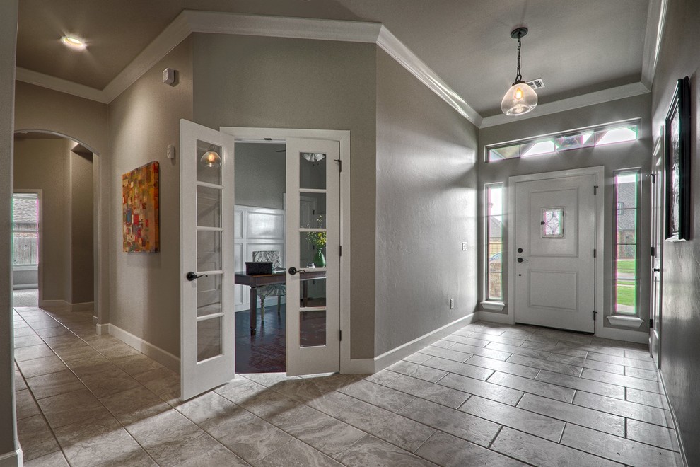 Inspiration for a mid-sized traditional front door in Oklahoma City with grey walls, ceramic floors, a single front door and a white front door.