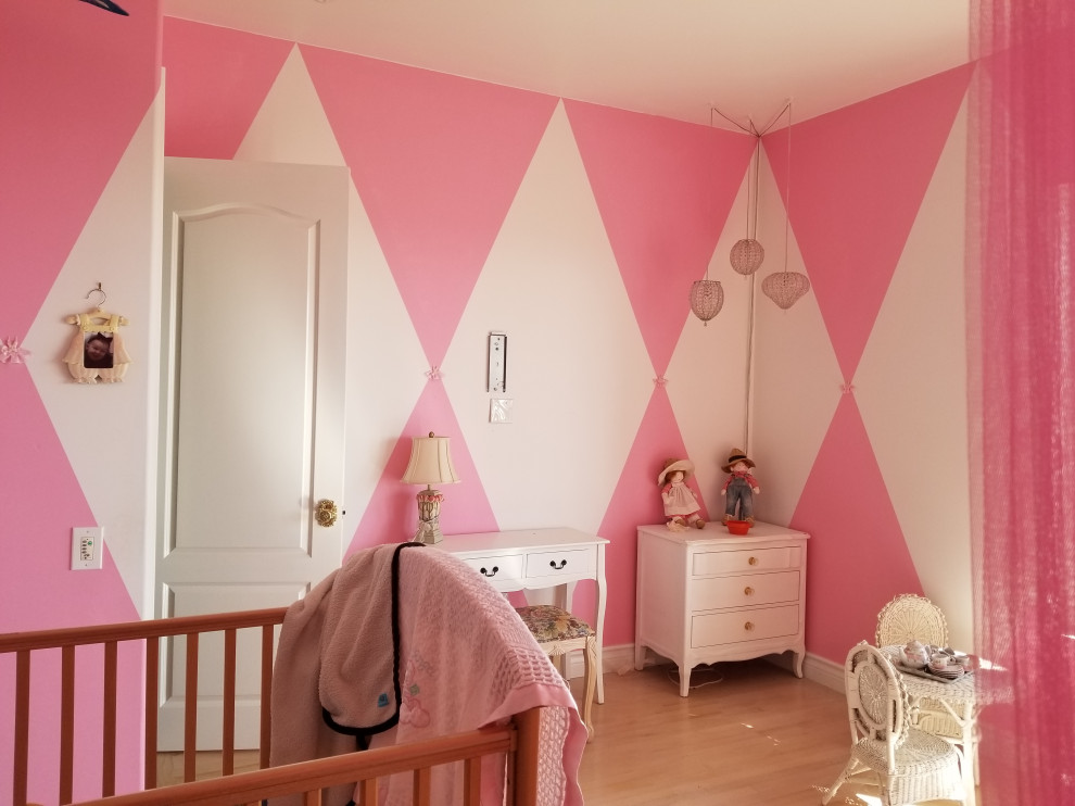Inspiration for a large traditional guest bedroom with pink walls, medium hardwood floors and white floor.