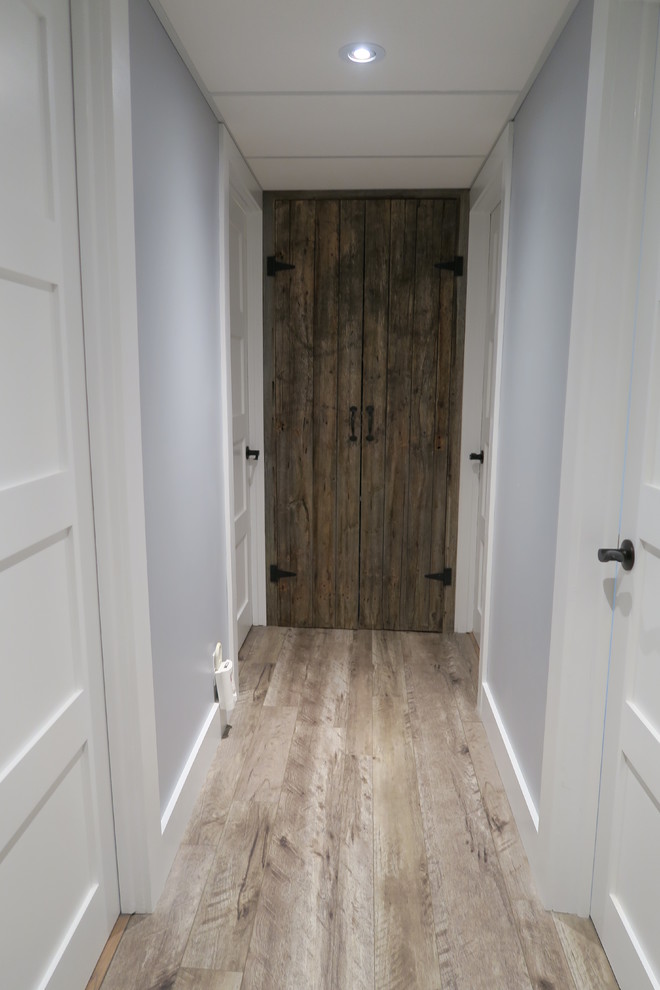 This is an example of a large transitional hallway in Ottawa with grey walls, light hardwood floors and beige floor.