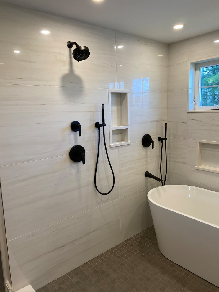 Inspiration for a large transitional master white tile and porcelain tile porcelain tile, gray floor and double-sink freestanding bathtub remodel in Boston with flat-panel cabinets, light wood cabinets, a one-piece toilet, white walls, an undermount sink, quartz countertops, a hinged shower door, white countertops and a floating vanity