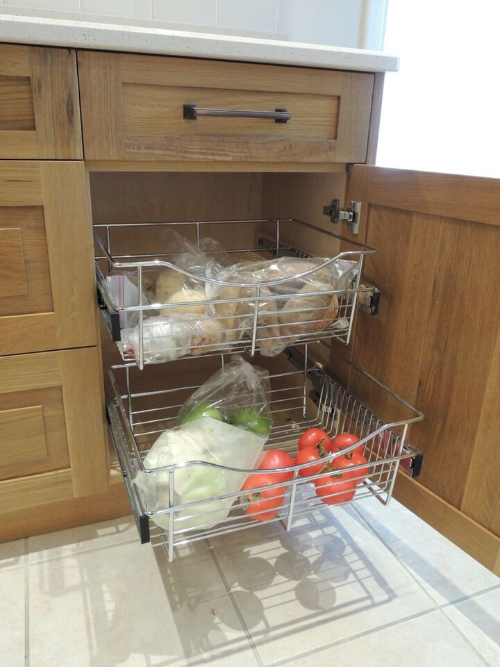 Mid-sized transitional l-shaped ceramic tile enclosed kitchen photo in Toronto with a double-bowl sink, shaker cabinets, light wood cabinets, quartz countertops, white backsplash, subway tile backsplash, stainless steel appliances and no island