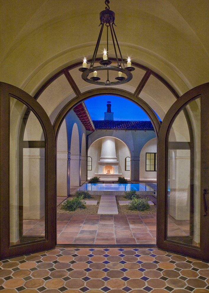 Inspiration for a mediterranean entryway in Austin with a double front door and a glass front door.
