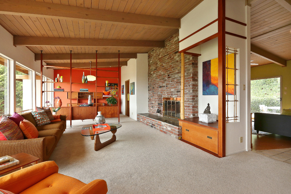 Large midcentury formal open concept living room in San Francisco with white walls, carpet, a standard fireplace, a brick fireplace surround, no tv and beige floor.