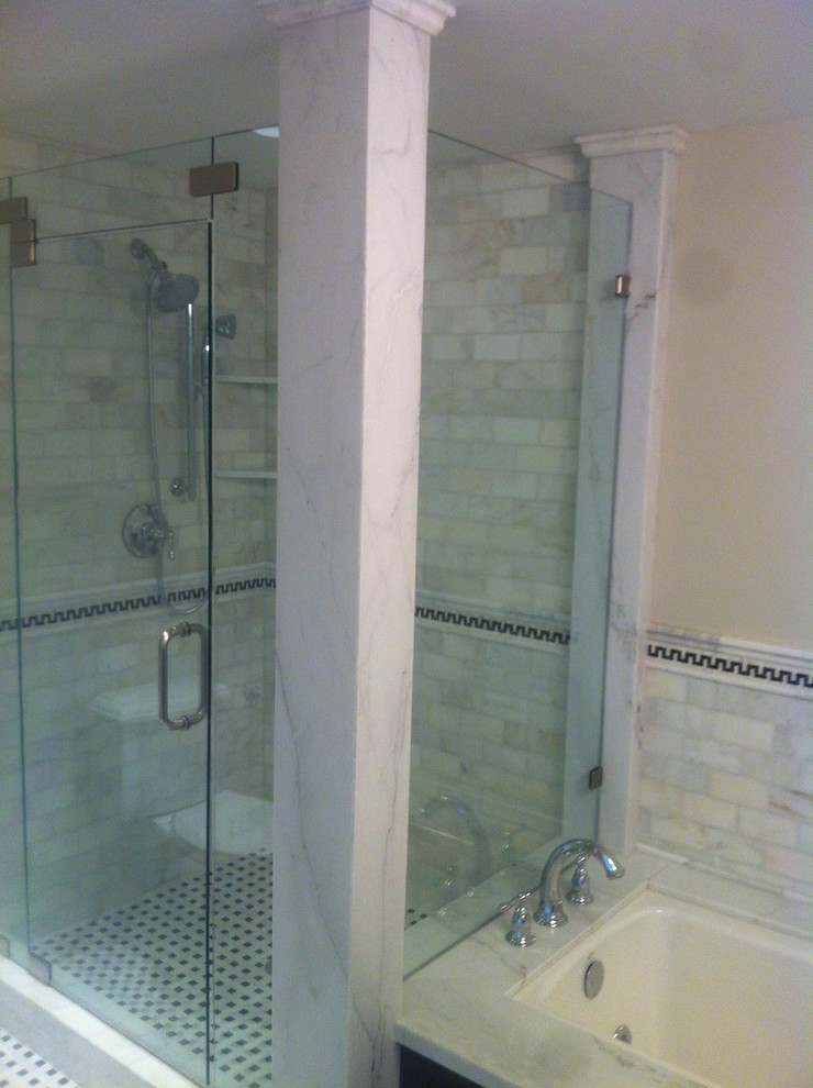 Photo of a traditional bathroom in Salt Lake City with a drop-in tub, an alcove shower, mosaic tile, beige walls, porcelain floors and marble benchtops.