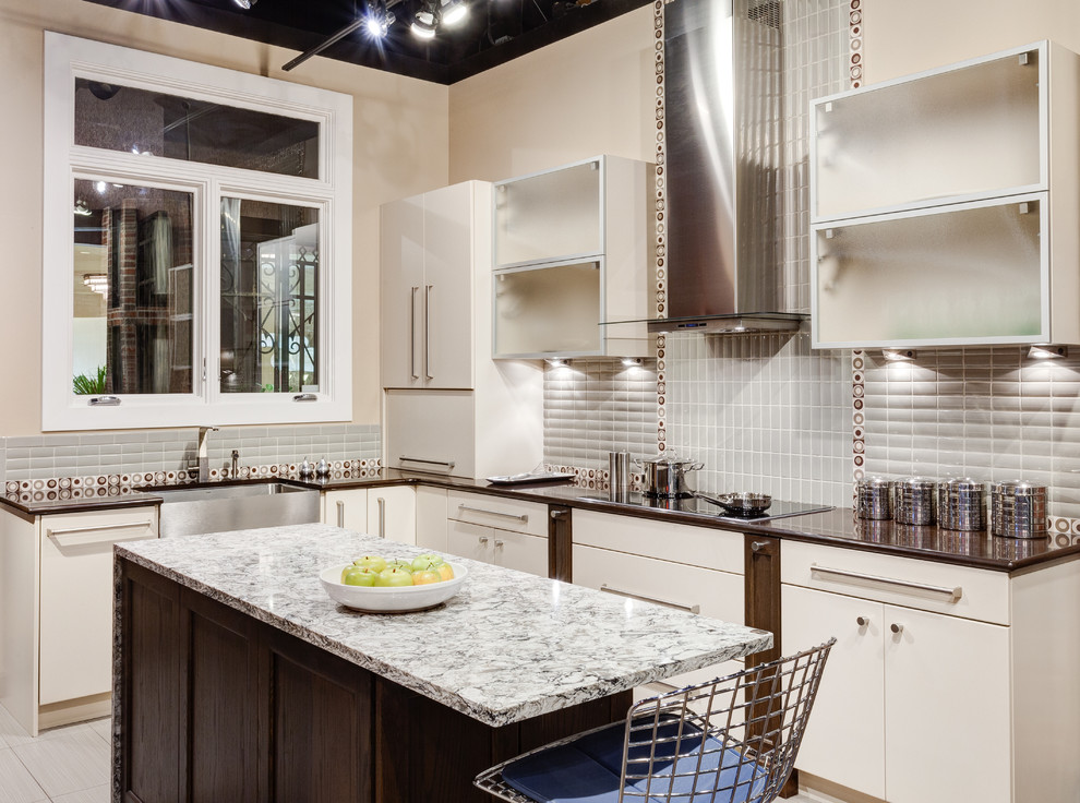 This is an example of a contemporary l-shaped eat-in kitchen in Chicago with quartz benchtops, a farmhouse sink, flat-panel cabinets, white cabinets and with island.