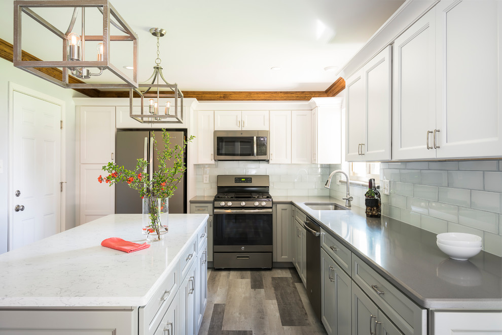 Inspiration for a country l-shaped separate kitchen in St Louis with shaker cabinets, yellow cabinets, quartz benchtops, blue splashback, glass tile splashback, stainless steel appliances, with island and grey benchtop.