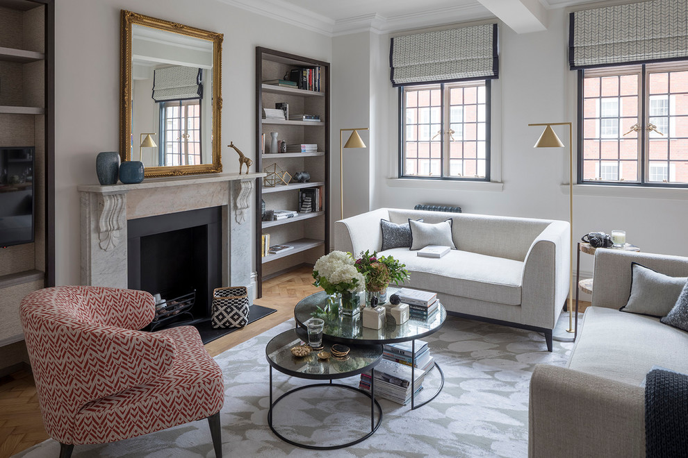 Mid-sized transitional formal enclosed living room in London with grey walls, a standard fireplace, a stone fireplace surround, beige floor and medium hardwood floors.