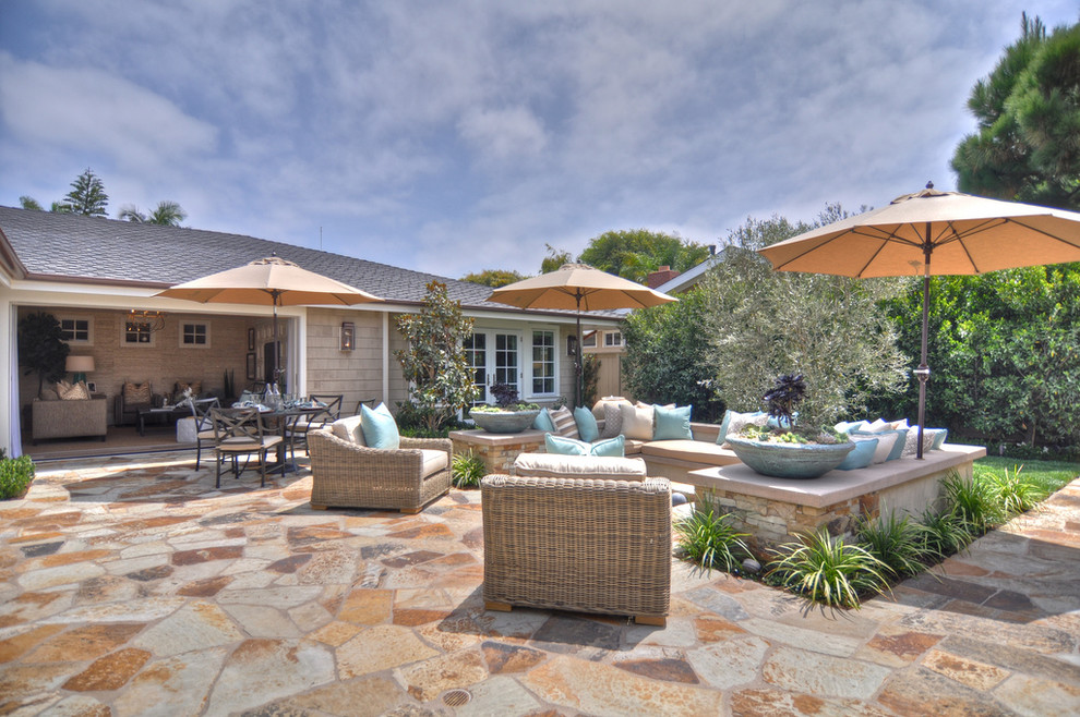 Beach style patio in Los Angeles with natural stone pavers and no cover.