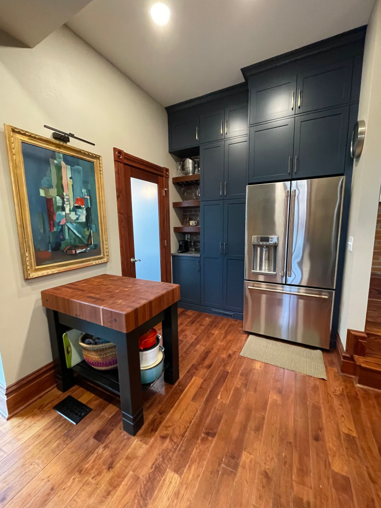 Inspiration for a small modern l-shaped medium tone wood floor and brown floor eat-in kitchen remodel in St Louis with an undermount sink, recessed-panel cabinets, blue cabinets, quartzite countertops, beige backsplash, ceramic backsplash, stainless steel appliances, no island and gray countertops
