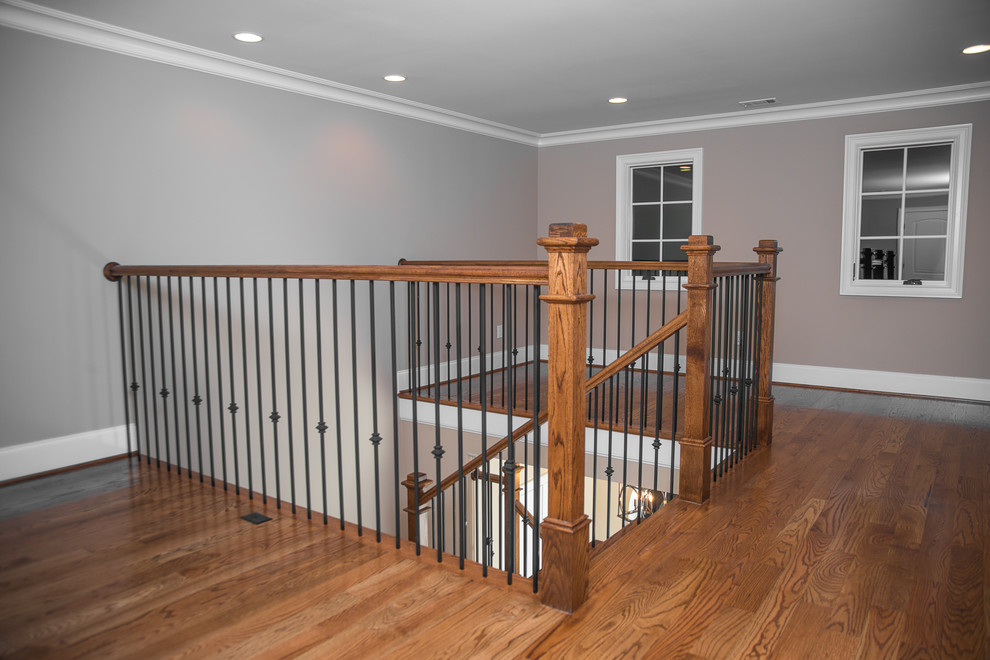Photo of a mid-sized traditional wood l-shaped staircase in Other with wood risers and wood railing.