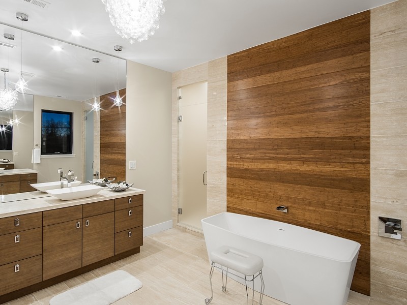 Design ideas for a contemporary master bathroom in Denver with flat-panel cabinets, dark wood cabinets, a freestanding tub, an alcove shower and a vessel sink.