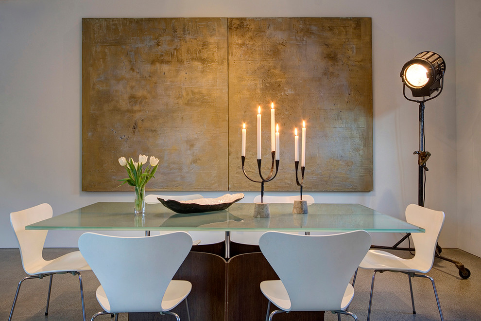 Photo of a country separate dining room in San Francisco with white walls and concrete floors.