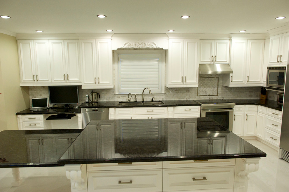 Example of a large classic u-shaped eat-in kitchen design in Toronto with an undermount sink, flat-panel cabinets, white cabinets and granite countertops