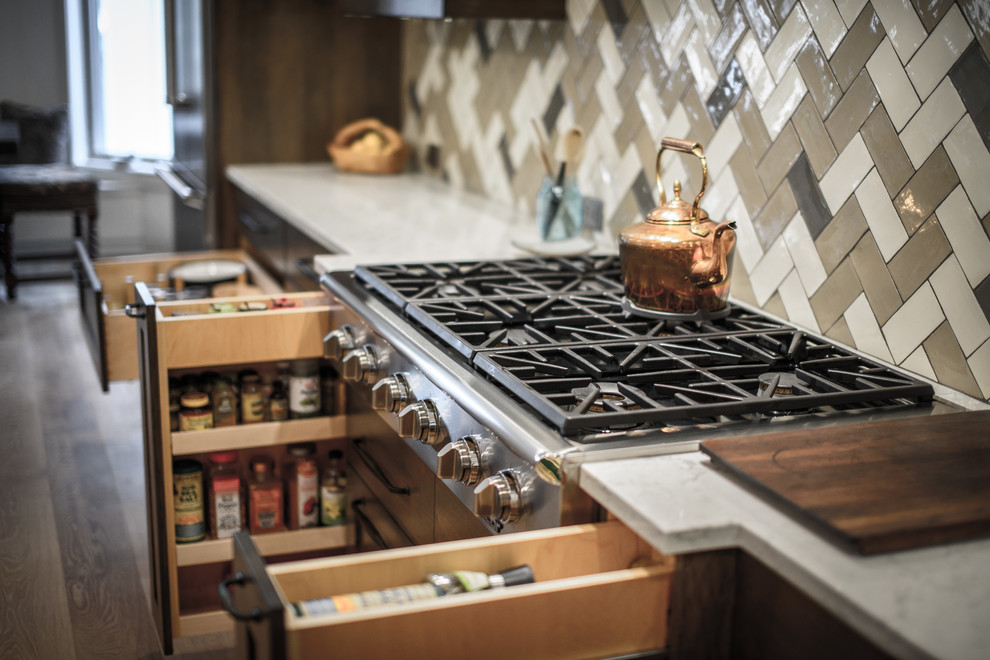 Home design - large transitional galley light wood floor home design idea in Jacksonville with a double-bowl sink, shaker cabinets, dark wood cabinets, quartz countertops, brown backsplash, ceramic backsplash, stainless steel appliances and two islands