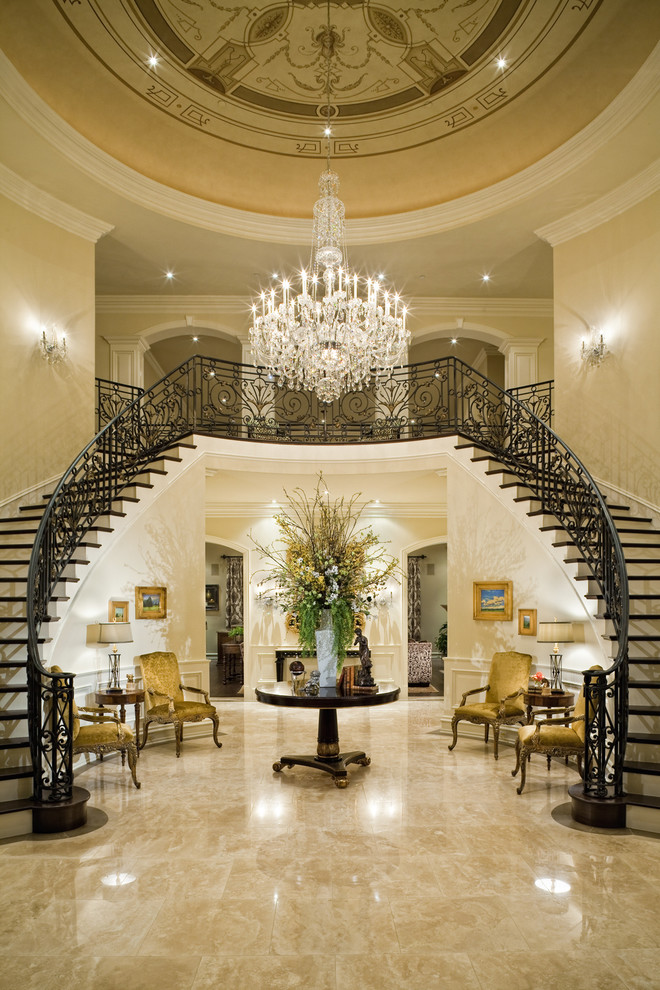Inspiration for an expansive traditional foyer in Los Angeles with beige walls and marble floors.