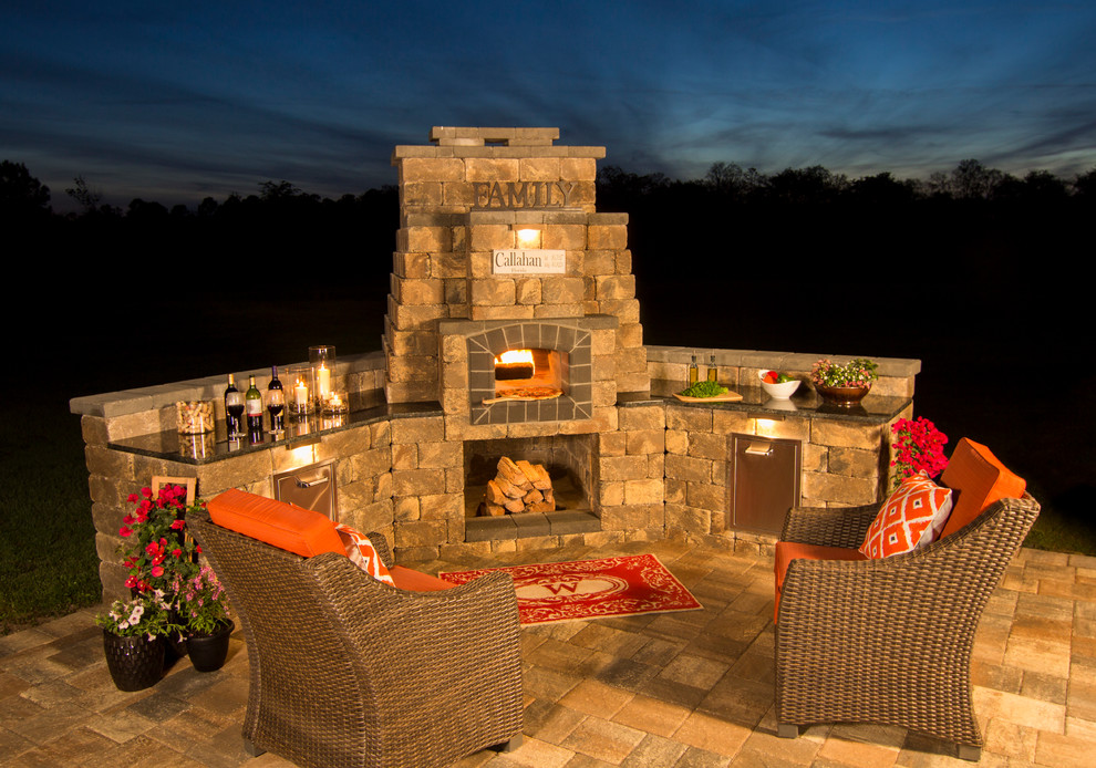 Inspiration for a small traditional backyard patio in Jacksonville with an outdoor kitchen, natural stone pavers and no cover.