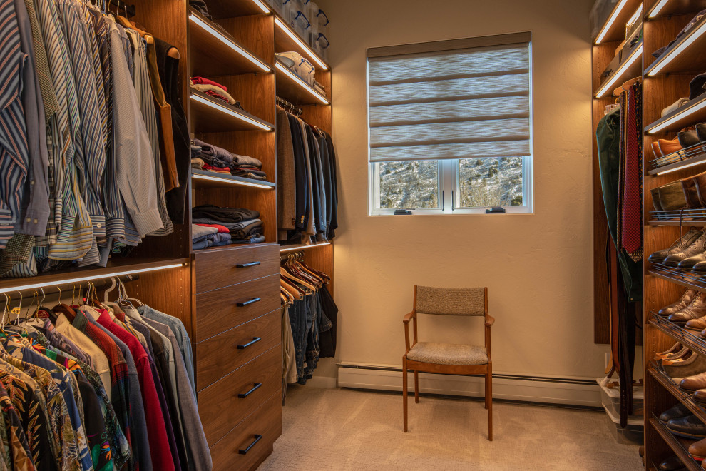 Inspiration for a large contemporary walk-in wardrobe in Albuquerque with medium wood cabinets, carpet and beige floor.