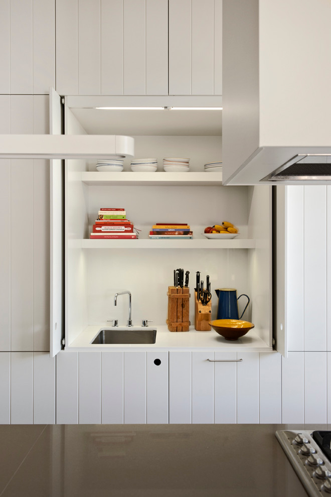 Contemporary kitchen in Melbourne with white cabinets.