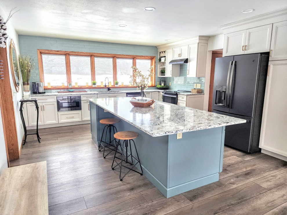 Inspiration for a mid-sized transitional l-shaped eat-in kitchen in Other with an undermount sink, flat-panel cabinets, quartz benchtops, glass tile splashback, black appliances, vinyl floors and with island.