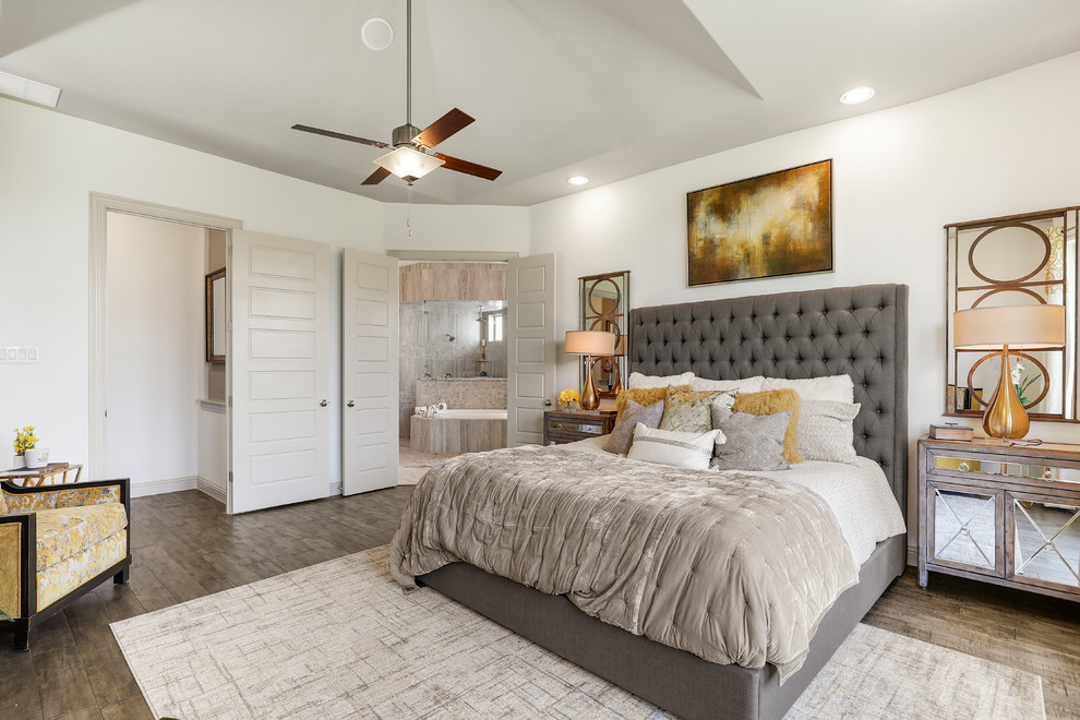 Photo of a large traditional master bedroom in Dallas with white walls, dark hardwood floors and brown floor.