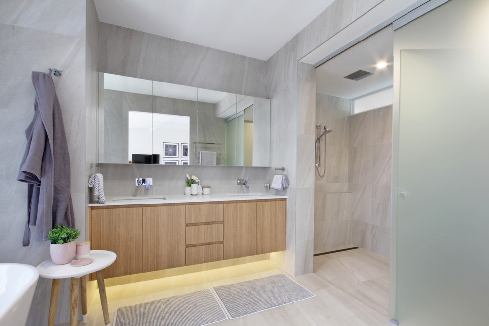 Small beach style master bathroom in Sunshine Coast with furniture-like cabinets, light wood cabinets, a freestanding tub, an open shower, white tile, porcelain tile, porcelain floors and engineered quartz benchtops.
