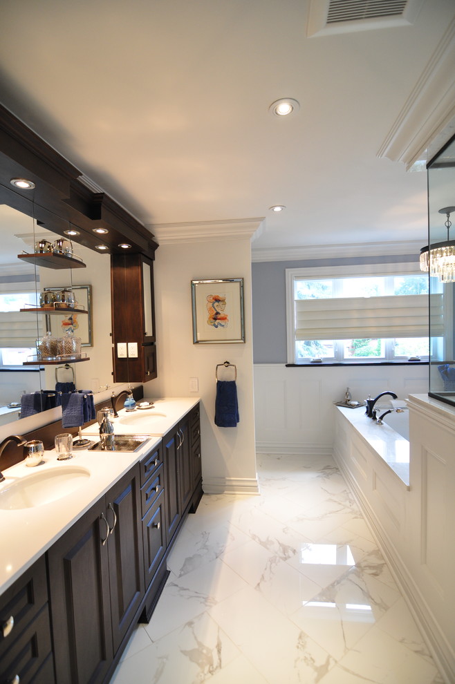 Design ideas for a mid-sized transitional master bathroom in Ottawa with an undermount sink, raised-panel cabinets, dark wood cabinets, engineered quartz benchtops, an undermount tub, white tile, mosaic tile, multi-coloured walls and ceramic floors.
