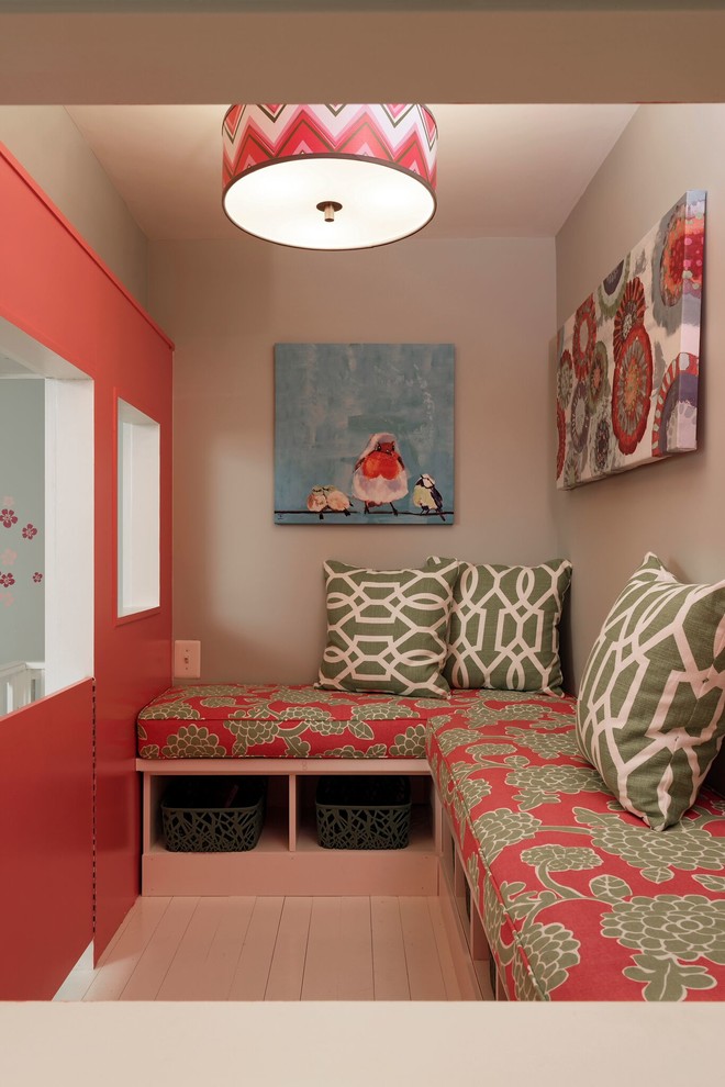 Creative and Unique Playroom - A perfect playroom space for two young girls to grow into.  The space contains a custom made playhouse, complete with hidden trap door, custom built in benches with plenty of toy storage and bench cushions for reading, lounging or play pretend.  In order to mimic an outdoor space, we added an indoor swing.  The side of the playhouse has a small soft area with green carpeting to mimic grass, and a small picket fence.  The tree wall stickers add to the theme.  A huge highlight to the space is the custom designed, custom built craft table with plenty of storage for all kinds of craft supplies.  The rustic laminate wood flooring adds to the cottage theme.
Bob Narod Photography