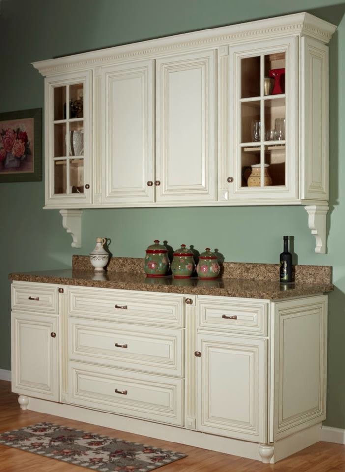 Photo of a transitional l-shaped kitchen in Other with raised-panel cabinets and granite benchtops.