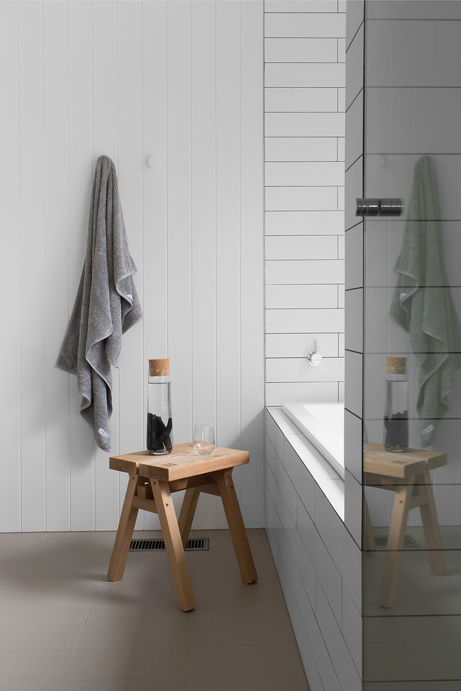 Inspiration for a country bathroom in Melbourne with a drop-in tub, white tile and white walls.