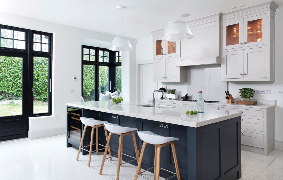 Design ideas for a large contemporary l-shaped eat-in kitchen in Dublin with shaker cabinets, grey cabinets, quartz benchtops, grey splashback, engineered quartz splashback, stainless steel appliances, with island and grey benchtop.