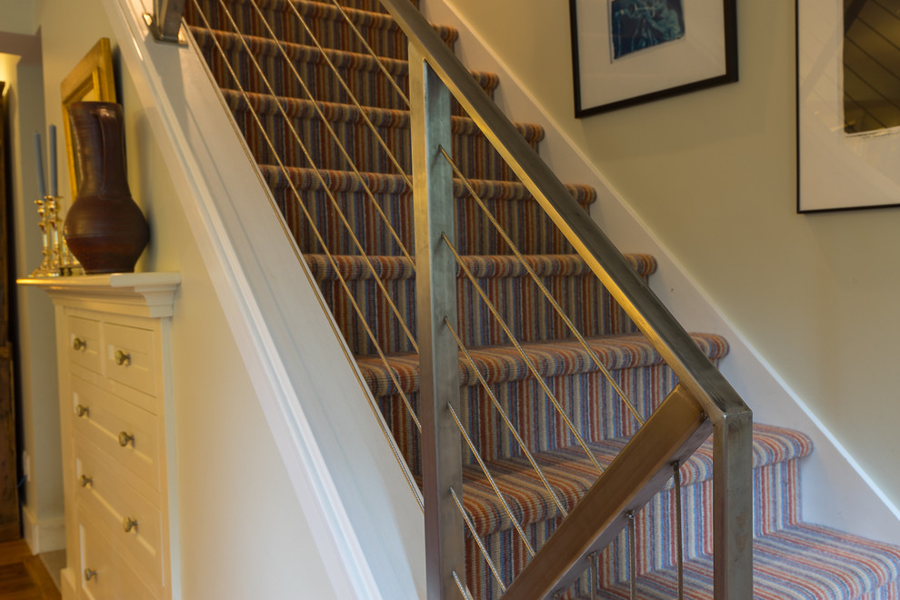 This is an example of an eclectic carpeted straight staircase in Burlington.