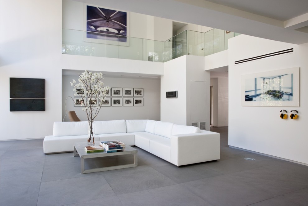 Photo of a modern formal living room in Kansas City with limestone floors, white walls and grey floor.