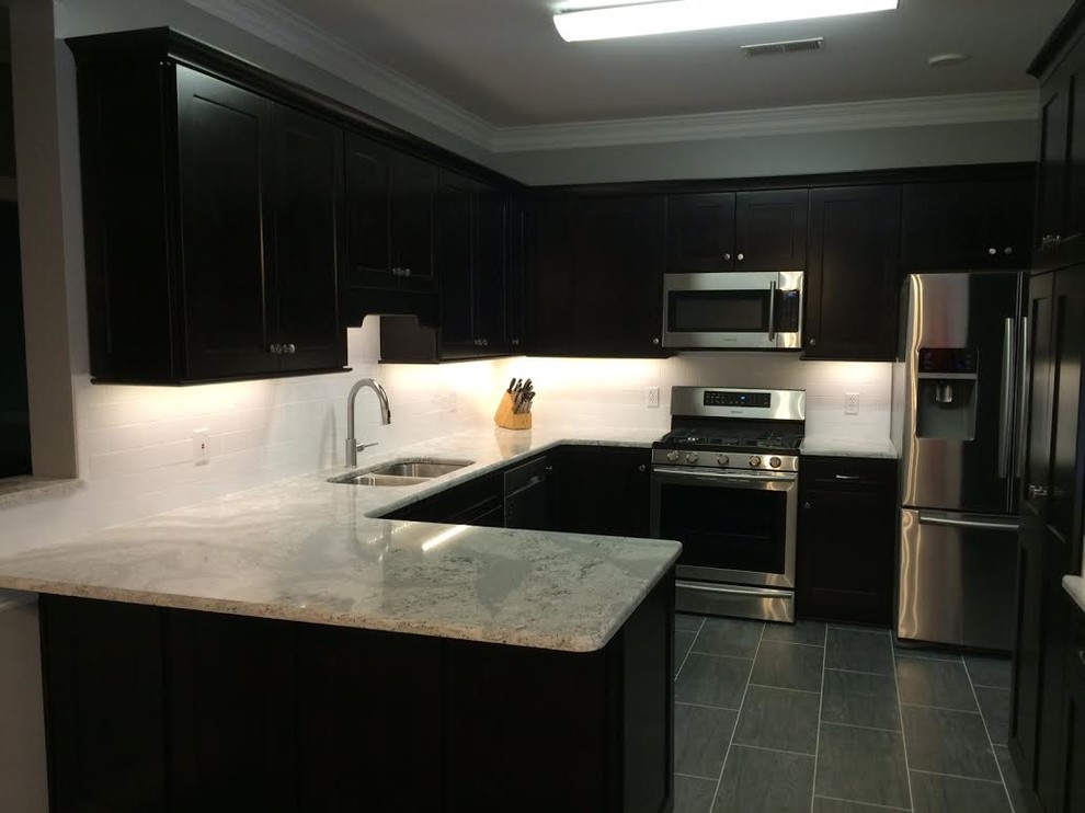 Example of a mid-sized transitional single-wall porcelain tile eat-in kitchen design in Other with an undermount sink, shaker cabinets, dark wood cabinets, quartz countertops, white backsplash, subway tile backsplash and stainless steel appliances