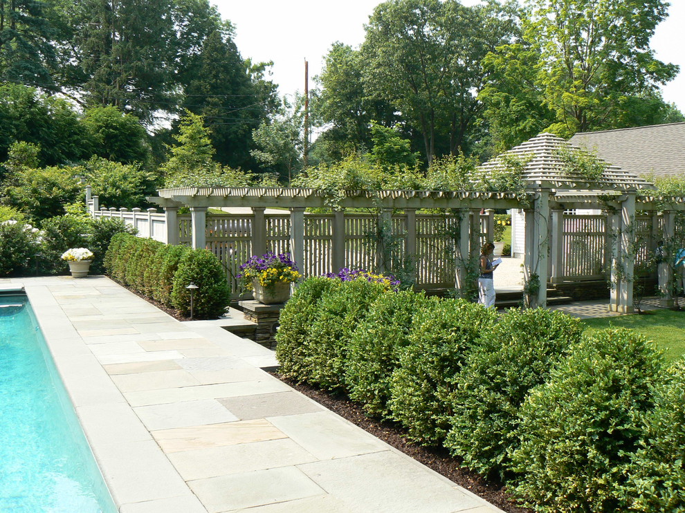 Traditional partial sun garden in New York with a wood fence.
