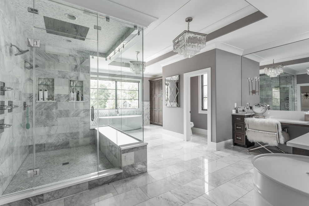 Expansive mediterranean master bathroom in Indianapolis with a freestanding tub, an open shower, gray tile, marble, grey walls and a hinged shower door.