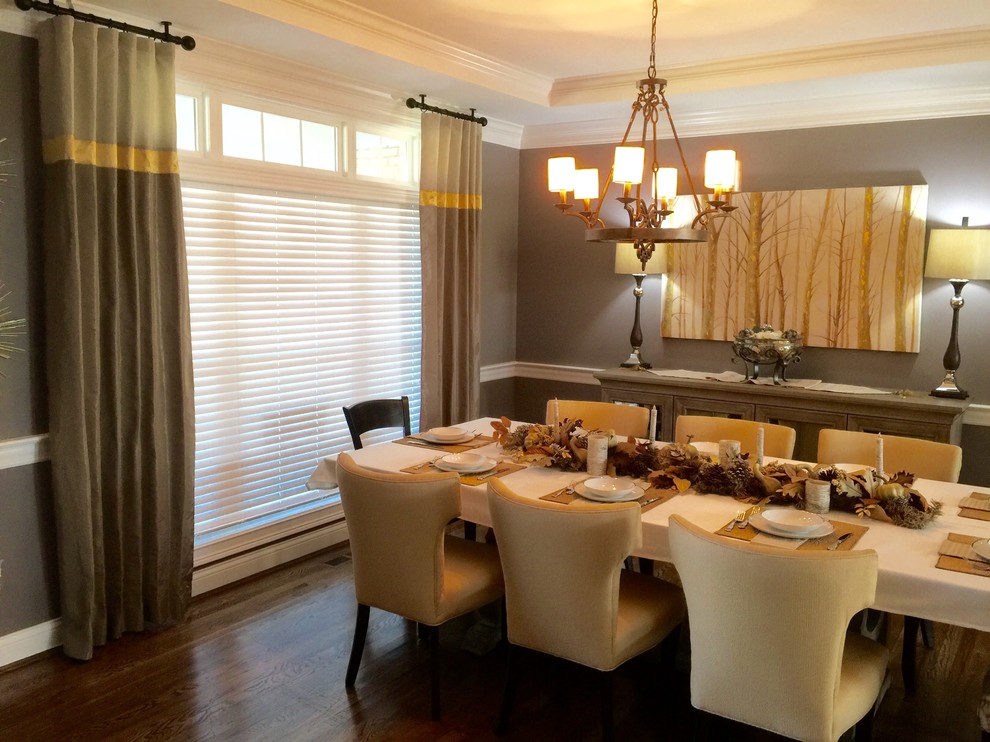 Mid-sized transitional separate dining room in Cincinnati with grey walls, no fireplace, medium hardwood floors and brown floor.