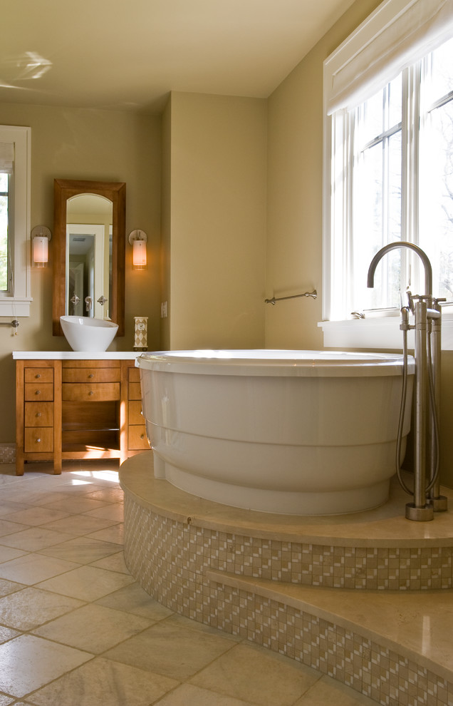 Mid-sized transitional master beige tile and ceramic tile porcelain tile freestanding bathtub photo in Baltimore with medium tone wood cabinets, a one-piece toilet, flat-panel cabinets, beige walls, a vessel sink and quartz countertops