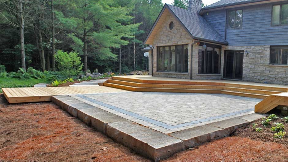 Example of a large mountain style backyard deck design in Toronto with no cover