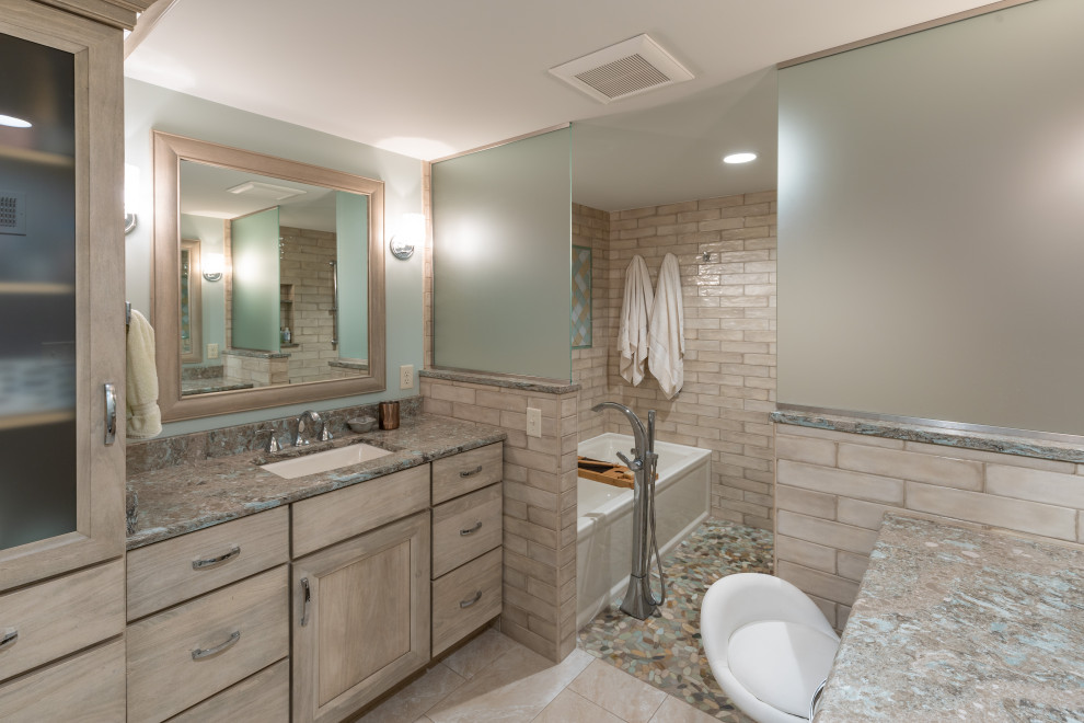 This is an example of a large classic ensuite bathroom in Kansas City with shaker cabinets, light wood cabinets, ceramic tiles, engineered stone worktops, multi-coloured worktops, a single sink, a built in vanity unit, an alcove bath, a shower/bath combination, beige tiles, green walls, mosaic tile flooring, a submerged sink, multi-coloured floors, an open shower and a wall niche.